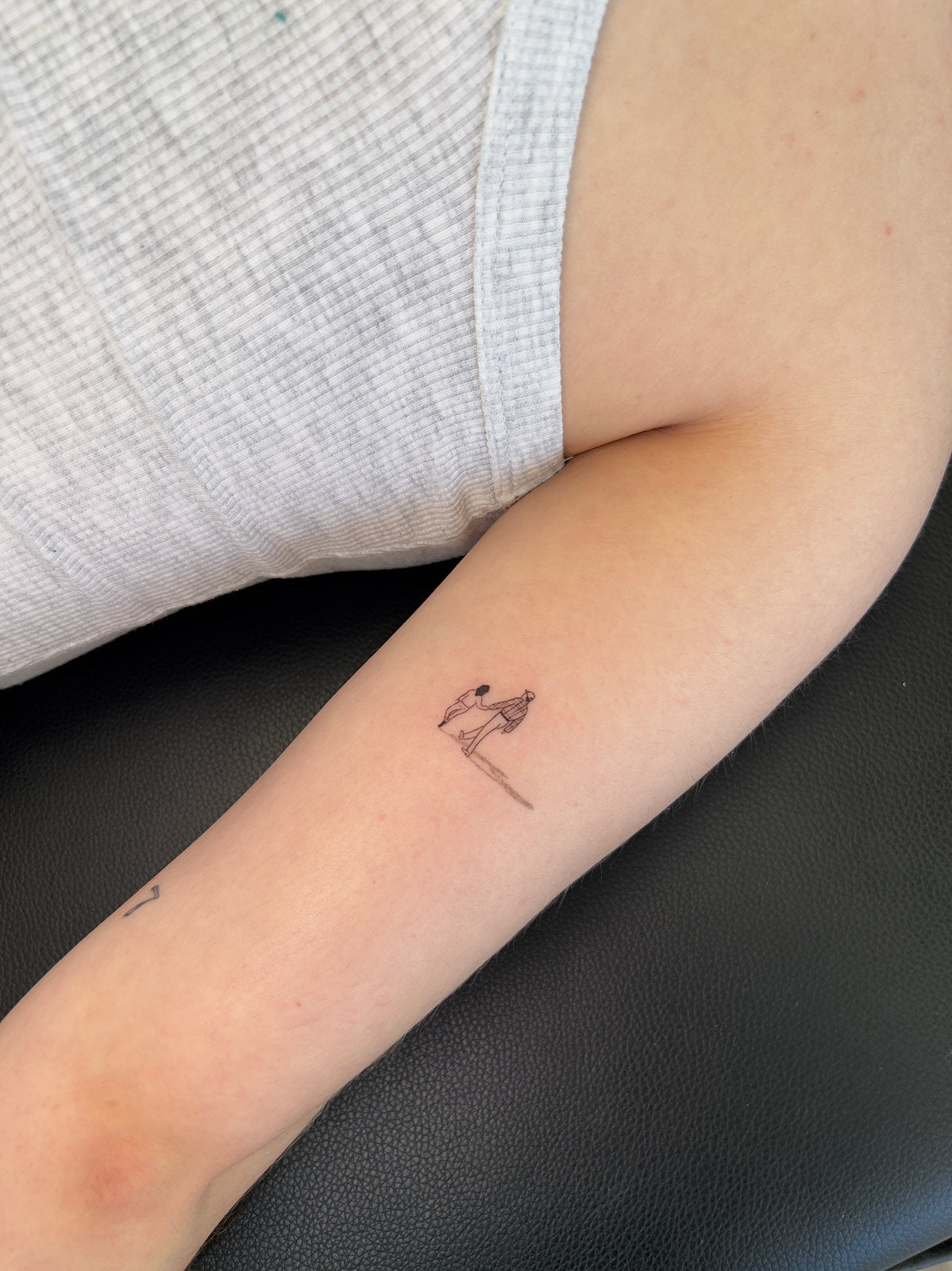 Tattoo of two small people in micro realistic
