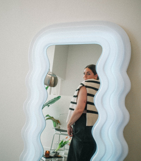 Cliente looking at herself in the miroir after a tattoo session
