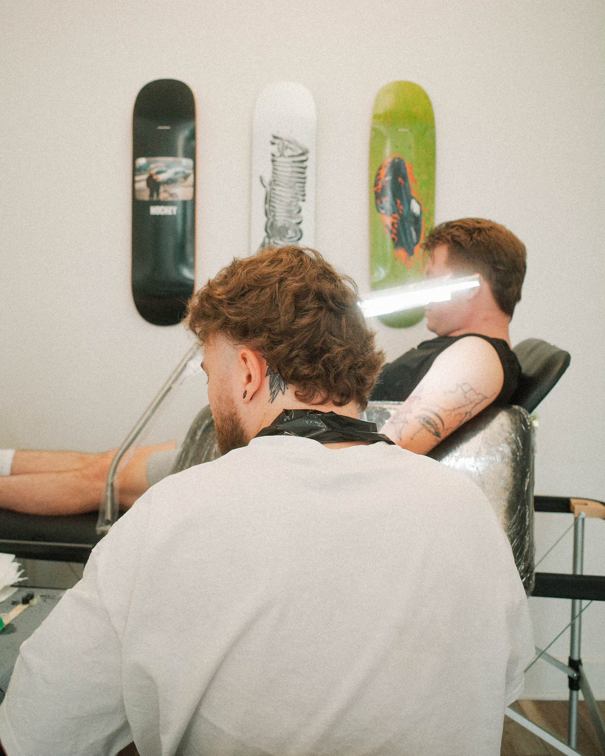 Tattoo artist tattoing a client's arm